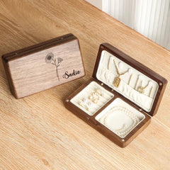 a wooden box with jewelry inside of it