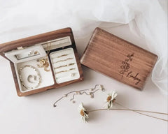 a wooden box filled with wedding rings and bracelets